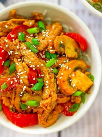 Soy curls with peppers and mushrooms in a white bowl.