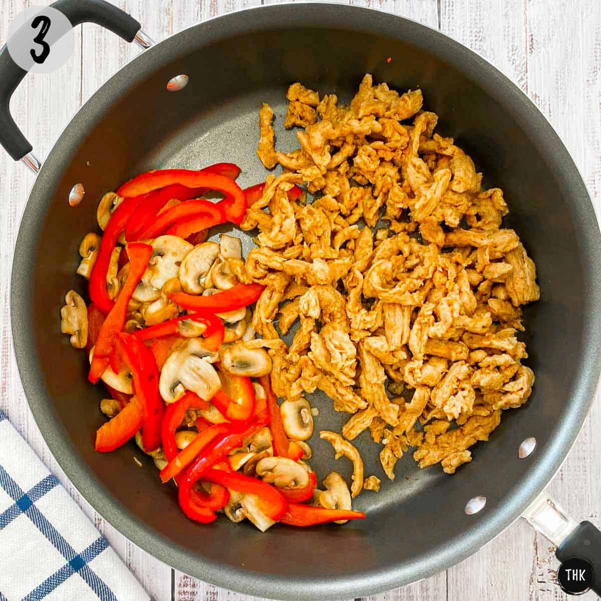 Sautéed mushrooms and peppers with soy curls inside skillet.