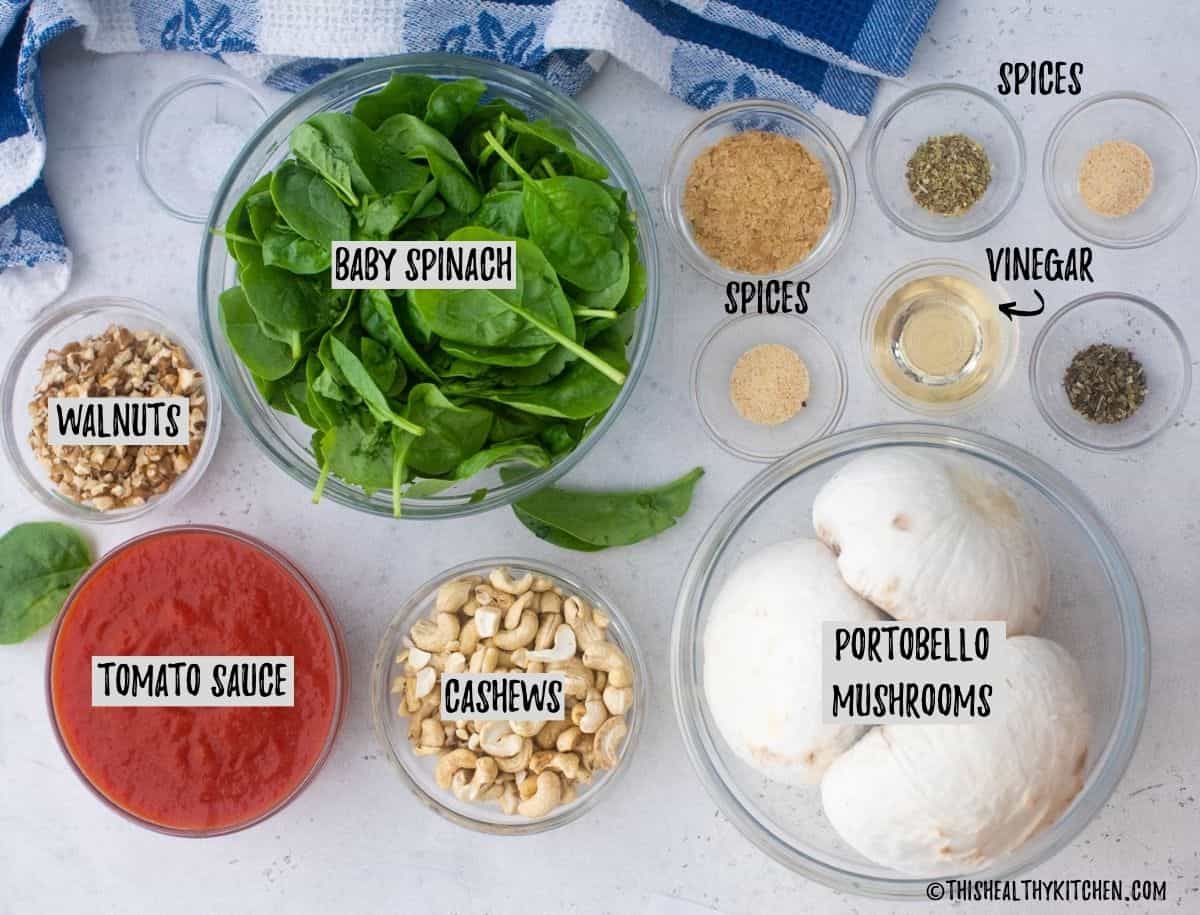 Ingredients needed to make vegan stuffed portobello mushrooms on counter.