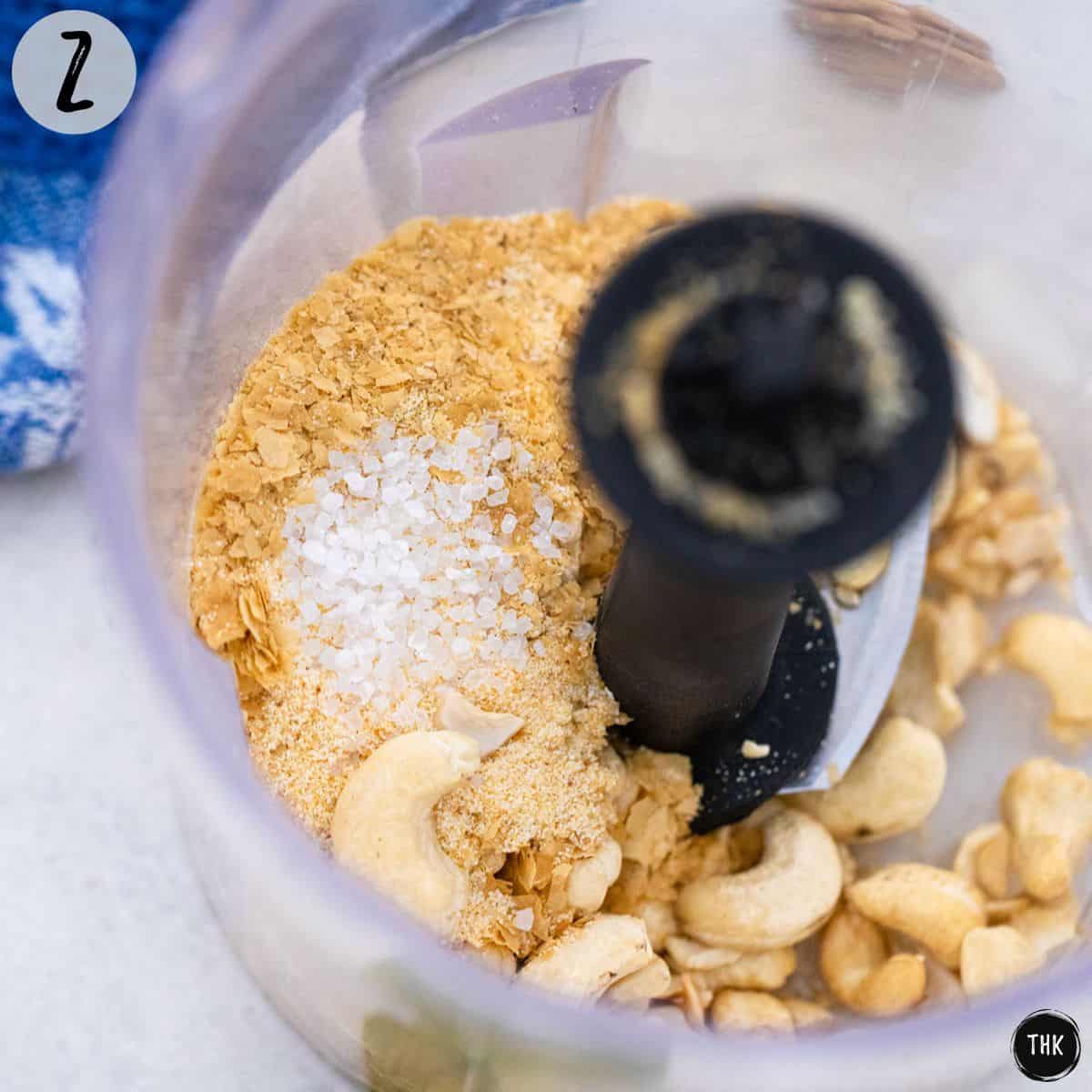 Cashews and spices inside food processor.