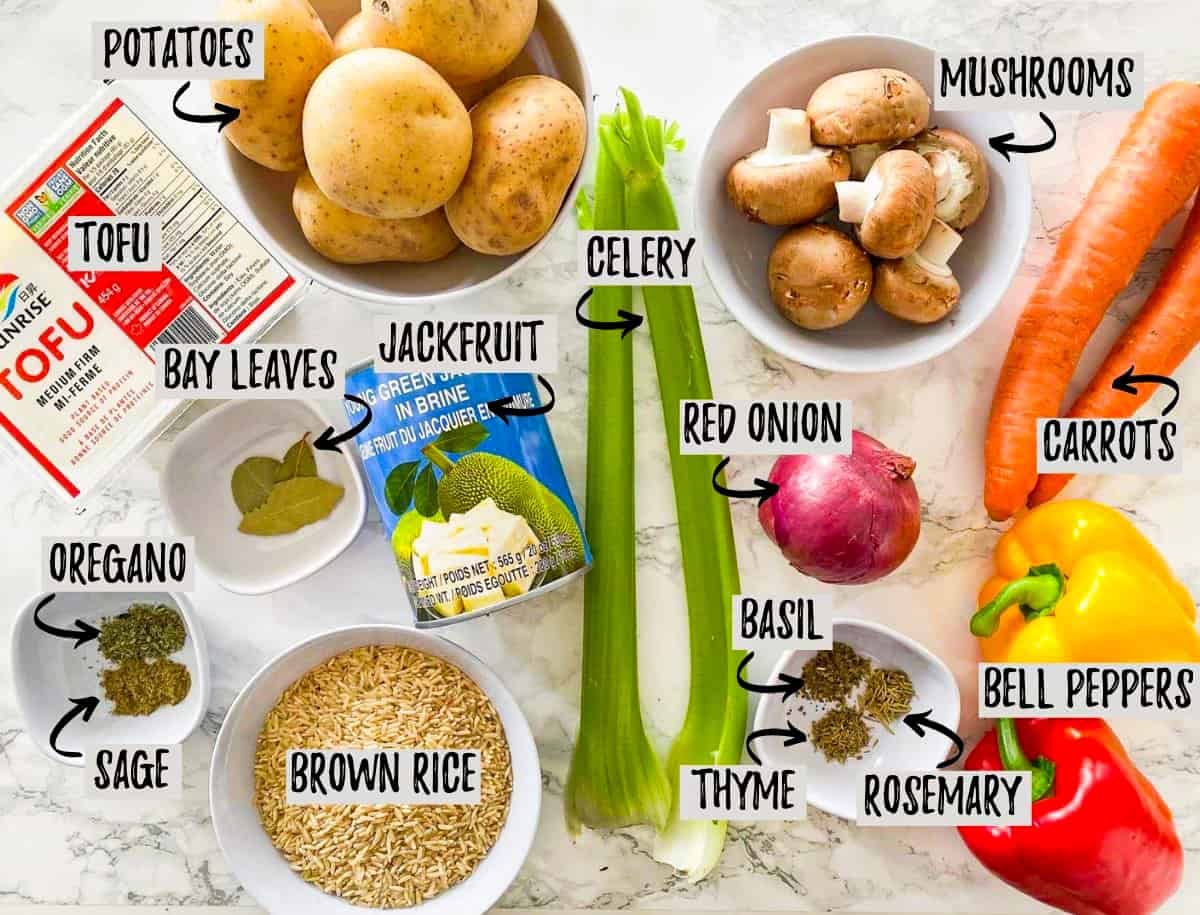 Ingredients needed to make vegan chicken soup on kitchen countertop.
