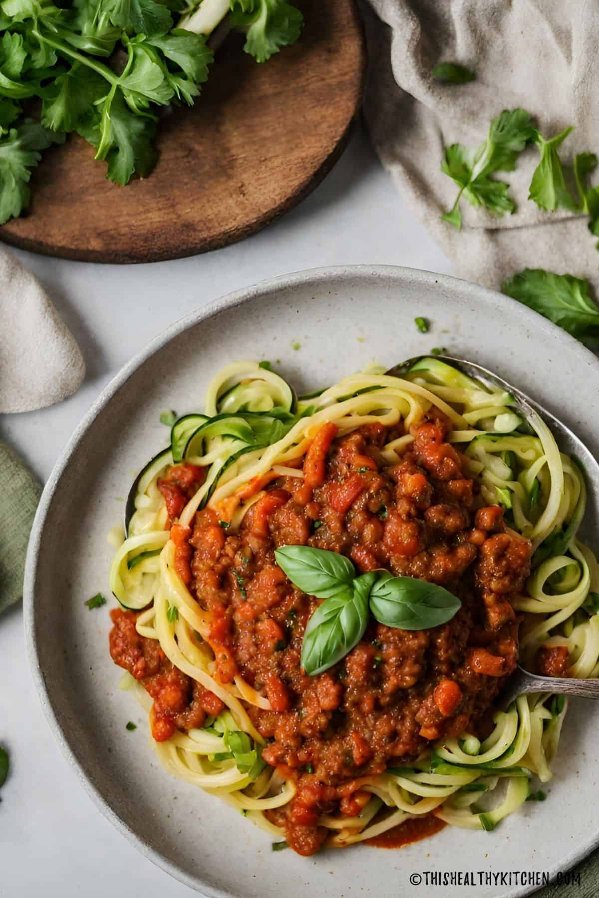 Zucchini noodles with vegan bolognese sauce on top.