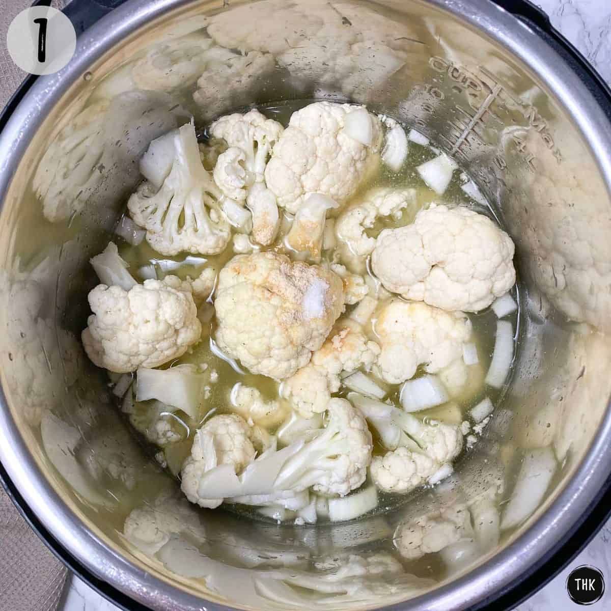 Cauliflower, broth and seasoning inside Instant Pot.