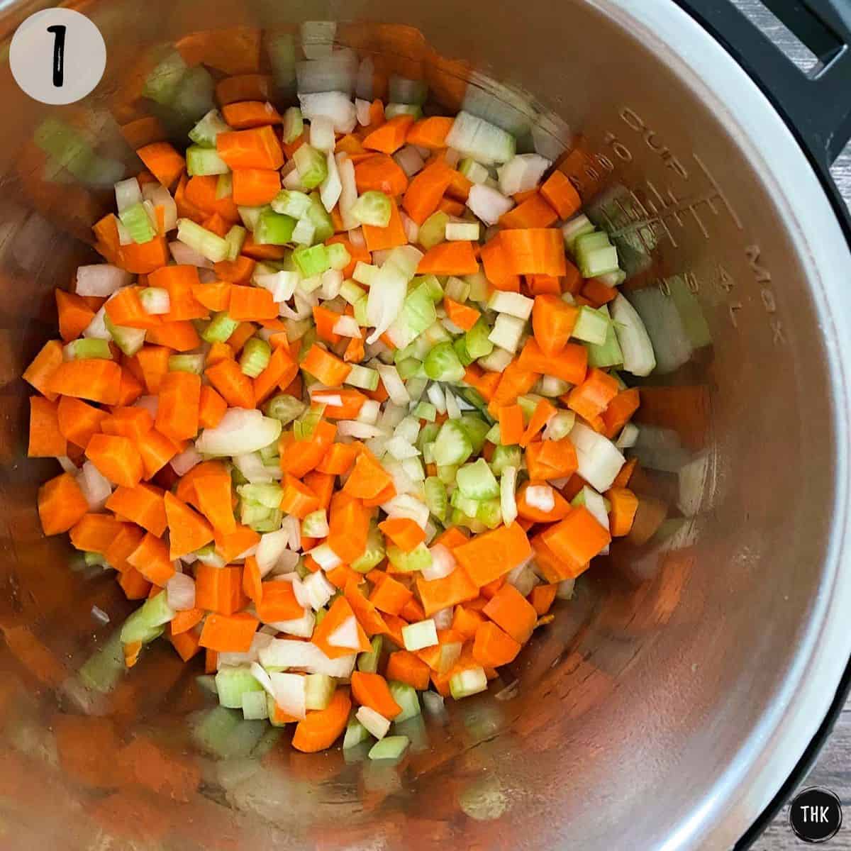 Chopped onion, carrots and celery inside Instant Pot.