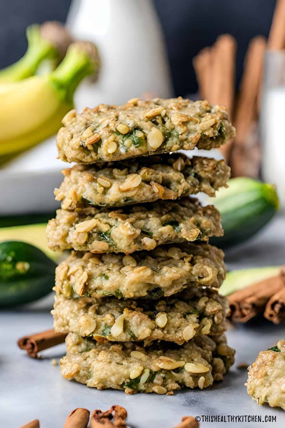 Six vegan zucchini cookies stacked on top of each other.