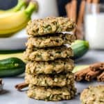 Six vegan zucchini cookies stacked on top of each other.