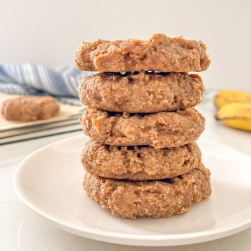 Stack of five vegan protein cookies on plate.