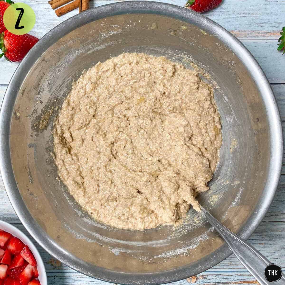 Banana bread batter inside large mixing bowl.