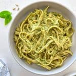 Bowl of fettuccini pasta covered in miso pesto sauce.