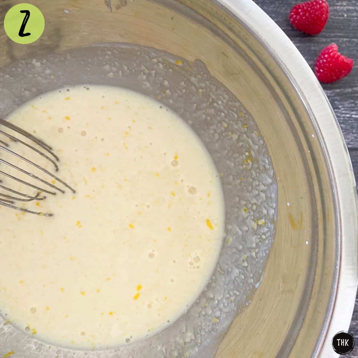 Mixing bowl with milk, lemon zest and applesauce inside.