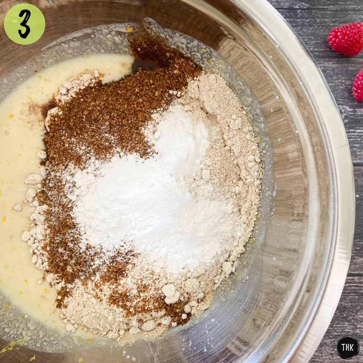 Mixing bowl with wet batter at the bottom and dry ingredients on top.