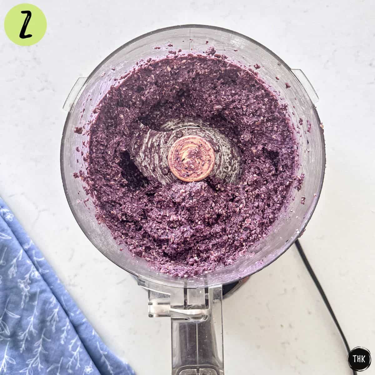 Blueberry mixture inside food processor.