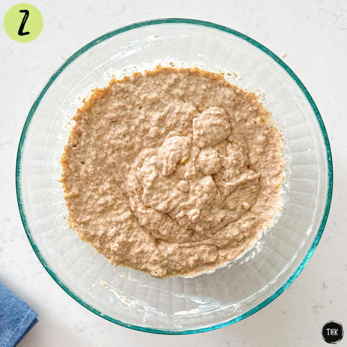 Waffle batter inside large glass bowl.