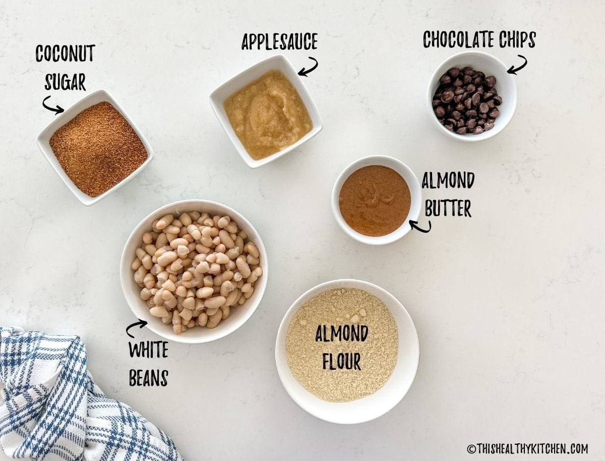 Ingredients needed to make vegan blondies in prep bowls on countertop.