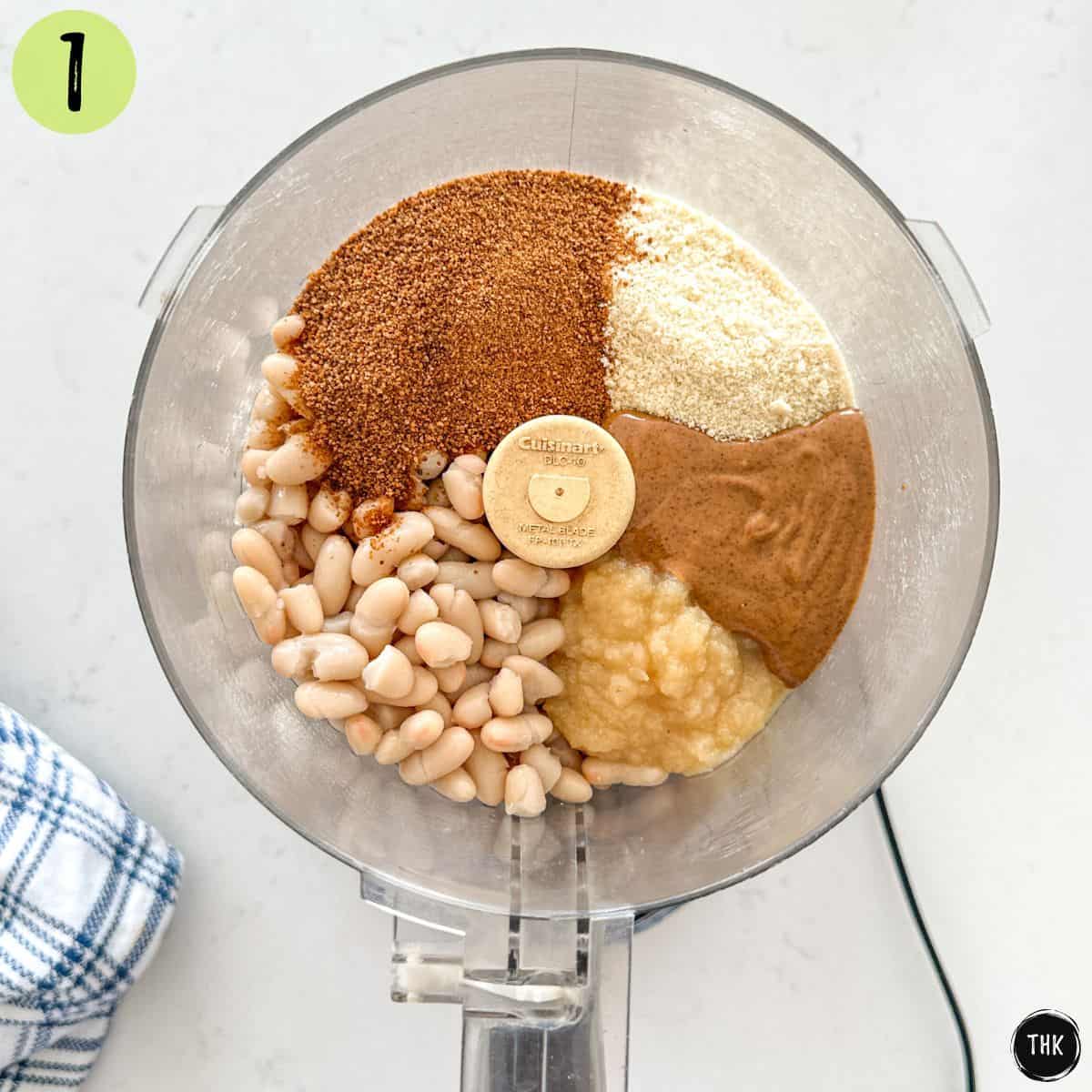 Flour, sugar, almond butter, applesauce and white beans inside food processor.