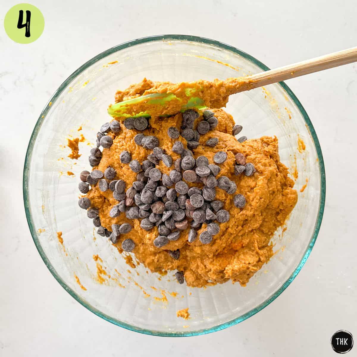 Banana pumpkin bread batter in large bowl with chocolate chips on top.