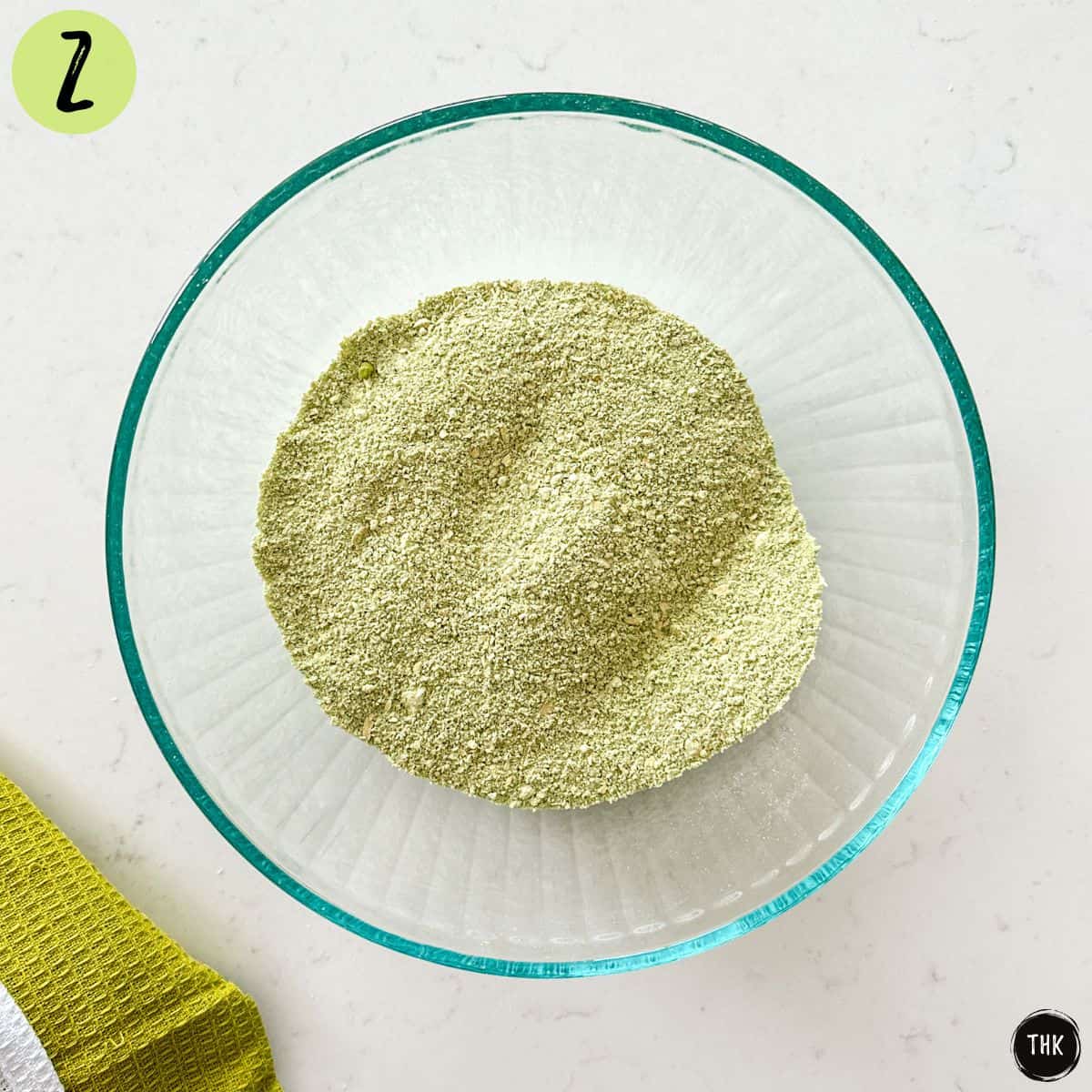 Green flour mixture inside large mixing bowl.