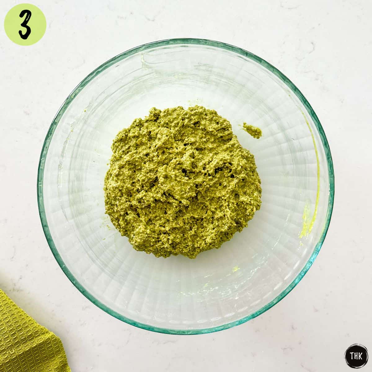 Green cookie batter inside large mixing bowl.