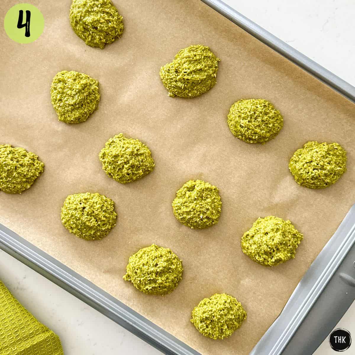 Unbaked green cookies on baking sheet.