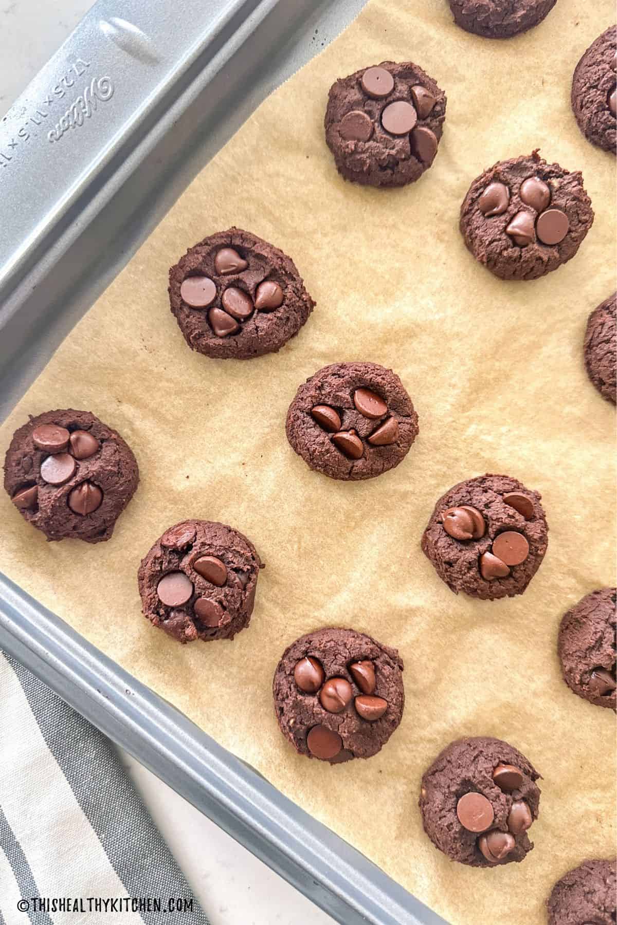 Baking sheet with double chocolate chickpea cookies on it.