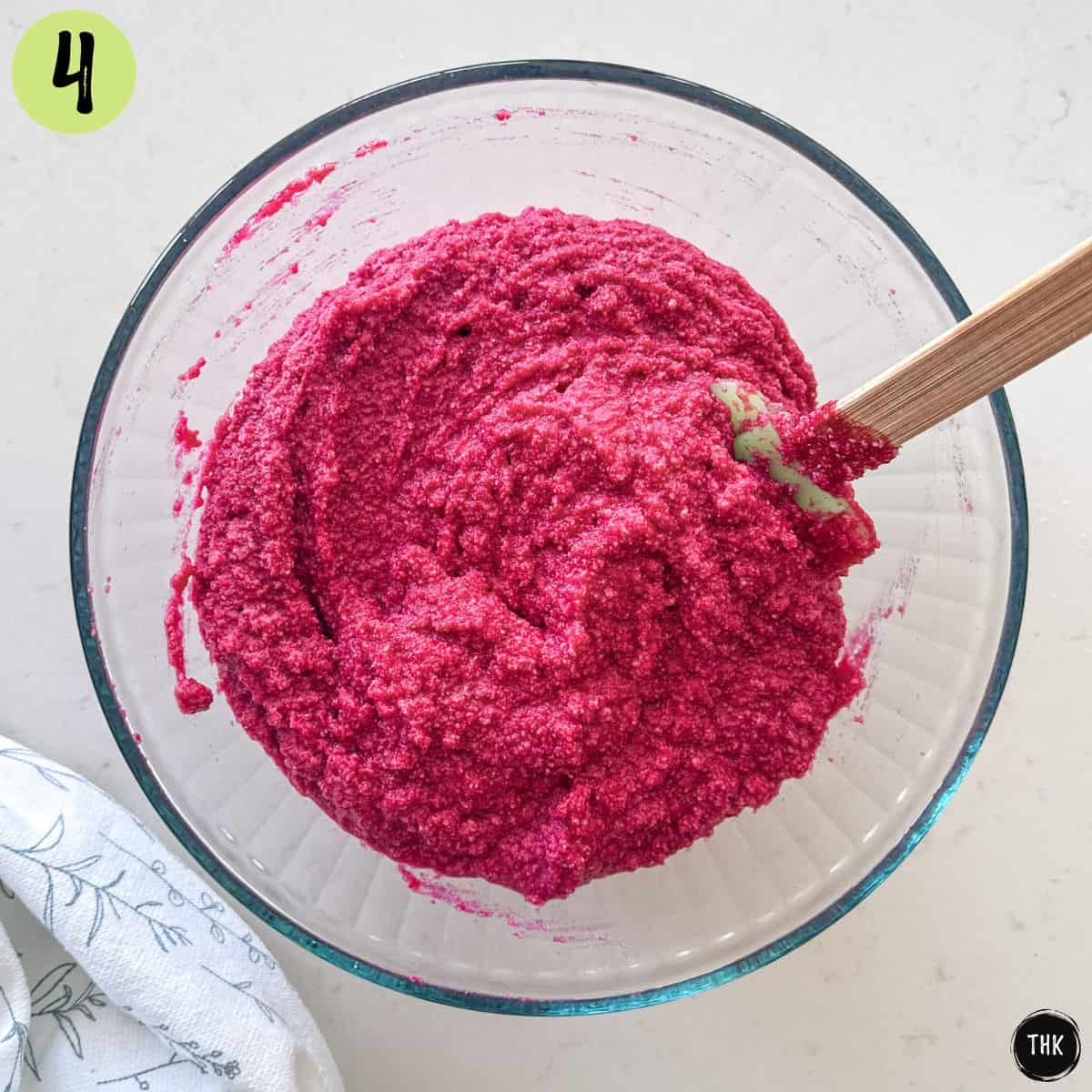 Bright pink muffin batter inside large mixing bowl.