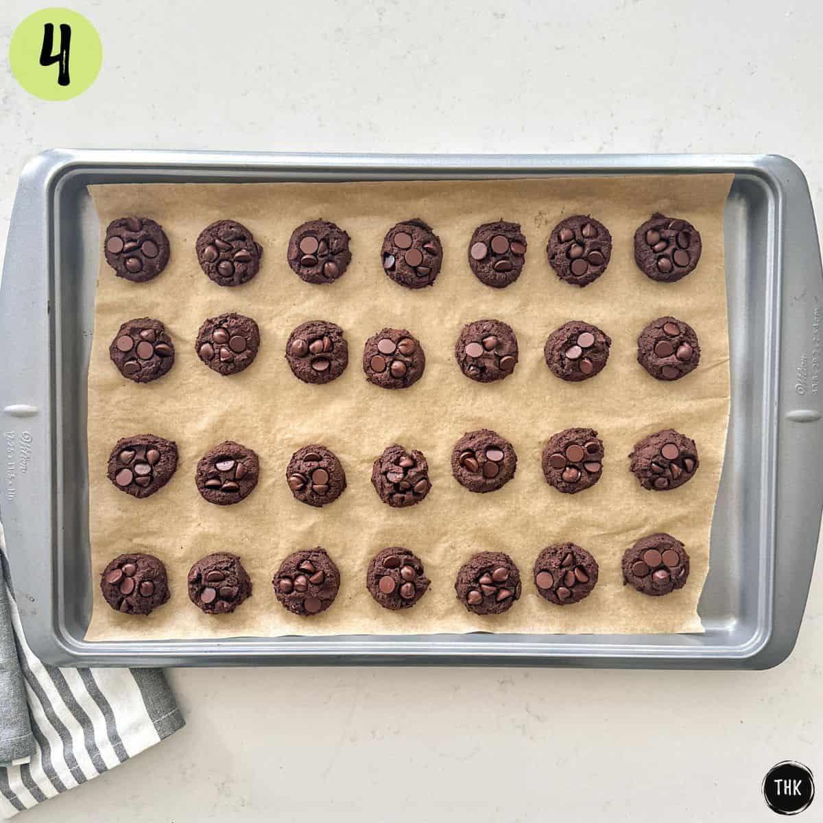 Baked double chocolate chip chickpea cookies on baking sheet.