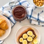 Jar of nut-free nutella with toast and chickpeas beside it.