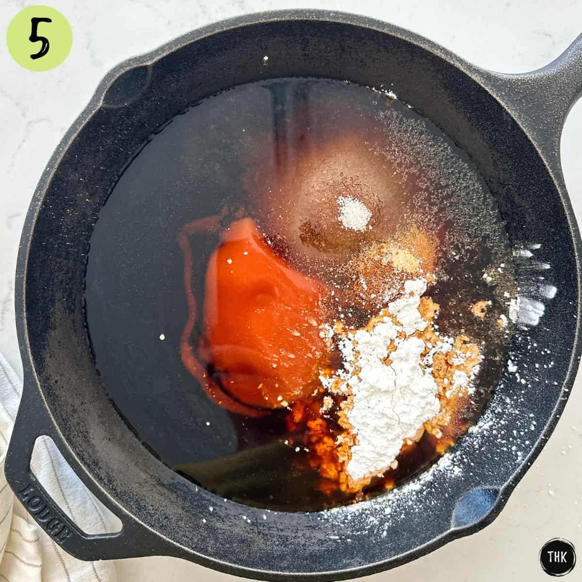Cast iron pan with spices and sauces for tofu marinade.