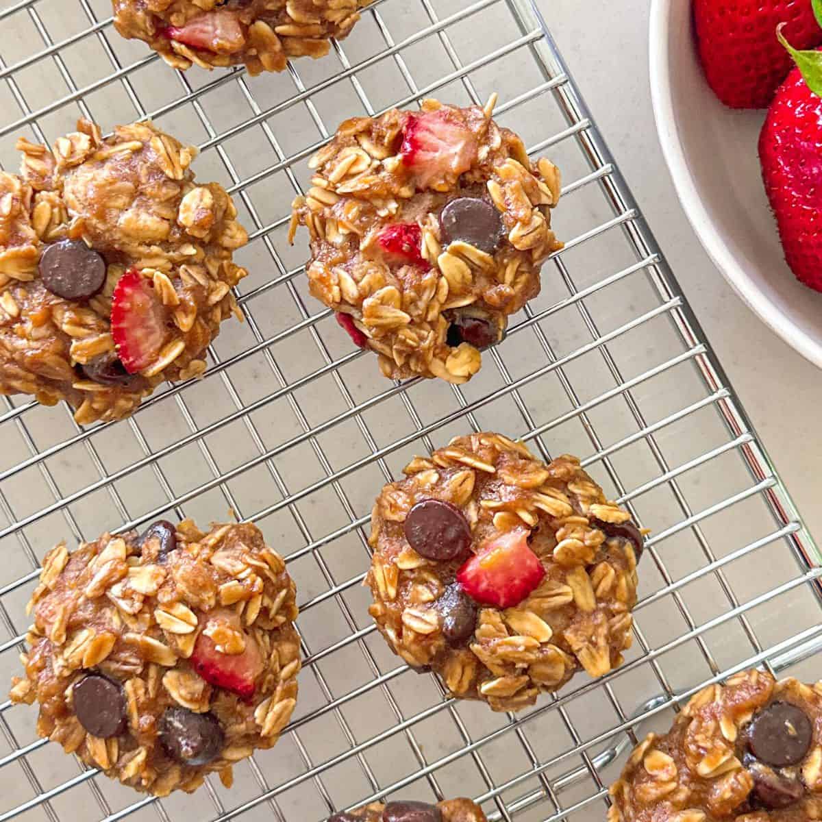 Strawberry chocolate chip oatmeal cookies on wire rack.