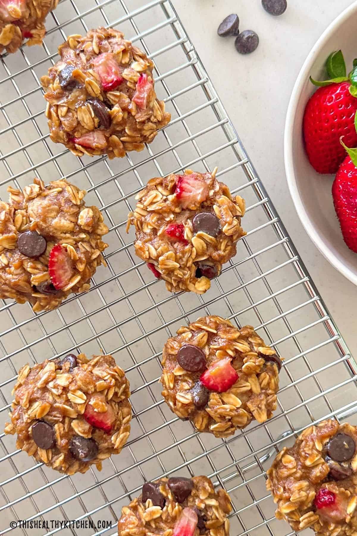 Strawberry chocolate chip oatmeal cookies on wire rack.