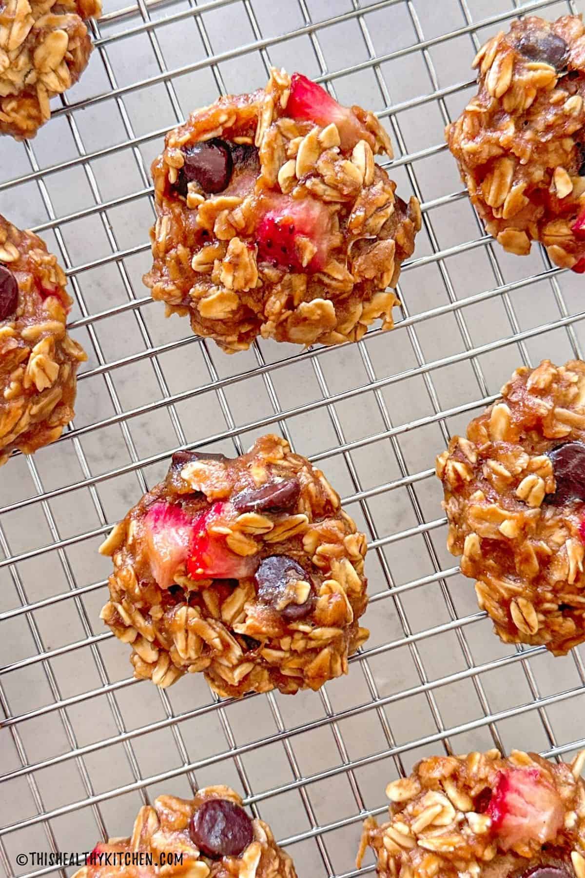 Strawberry chocolate chip oatmeal cookies on wire rack.