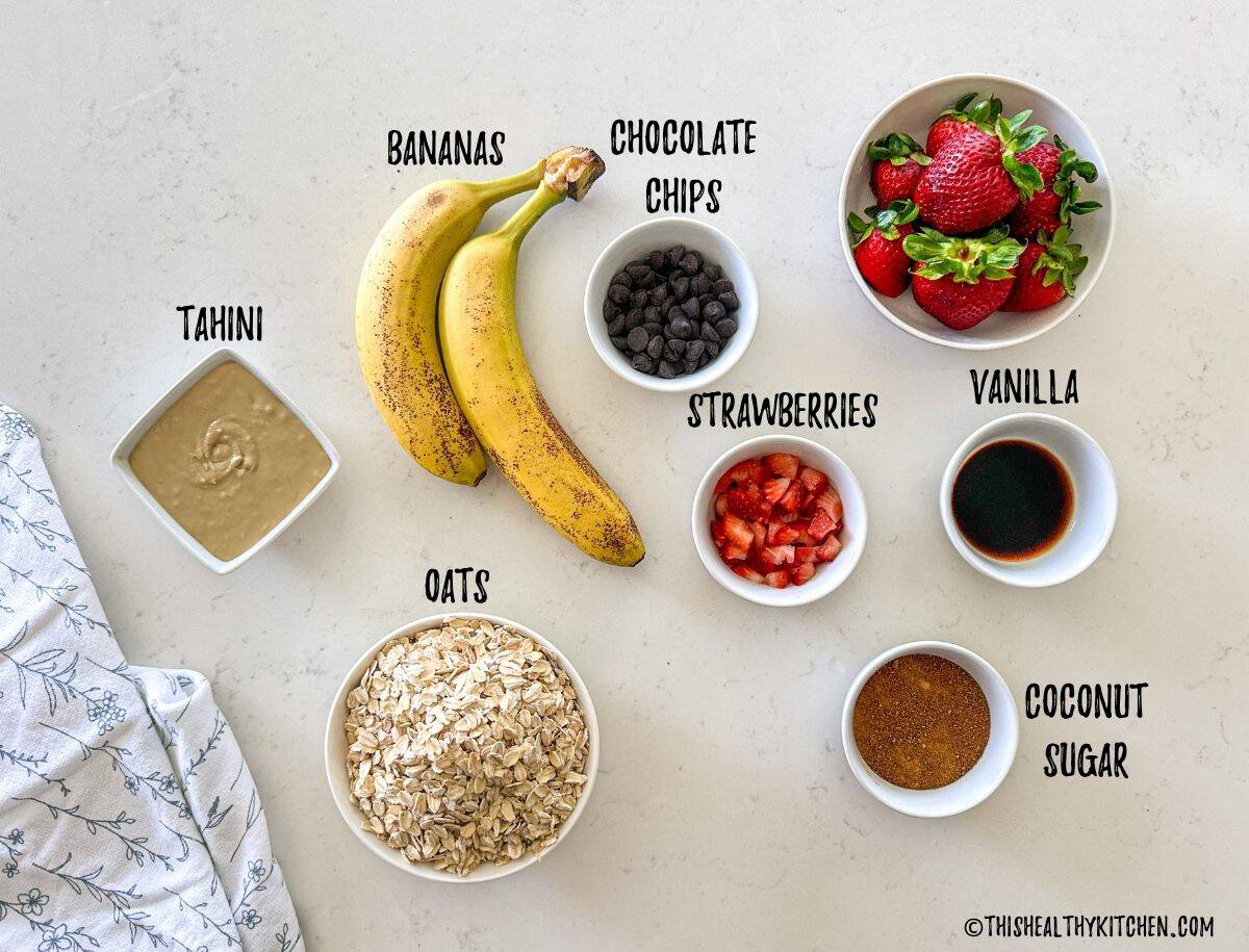Ingredients needed to make strawberry cookies in prep bowls on countertop.