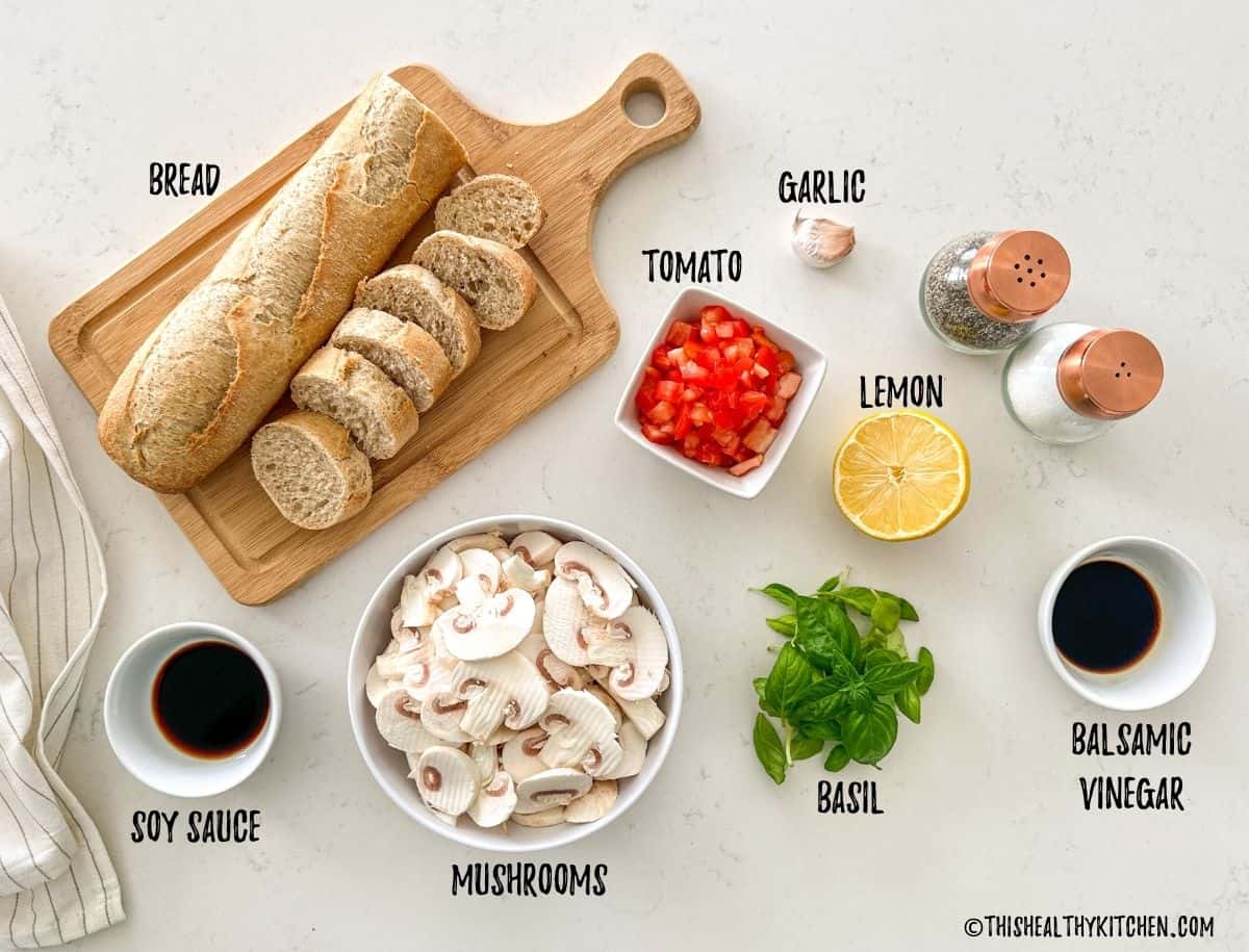 Ingredients needed to make mushroom bruschetta on kitchen countertop.