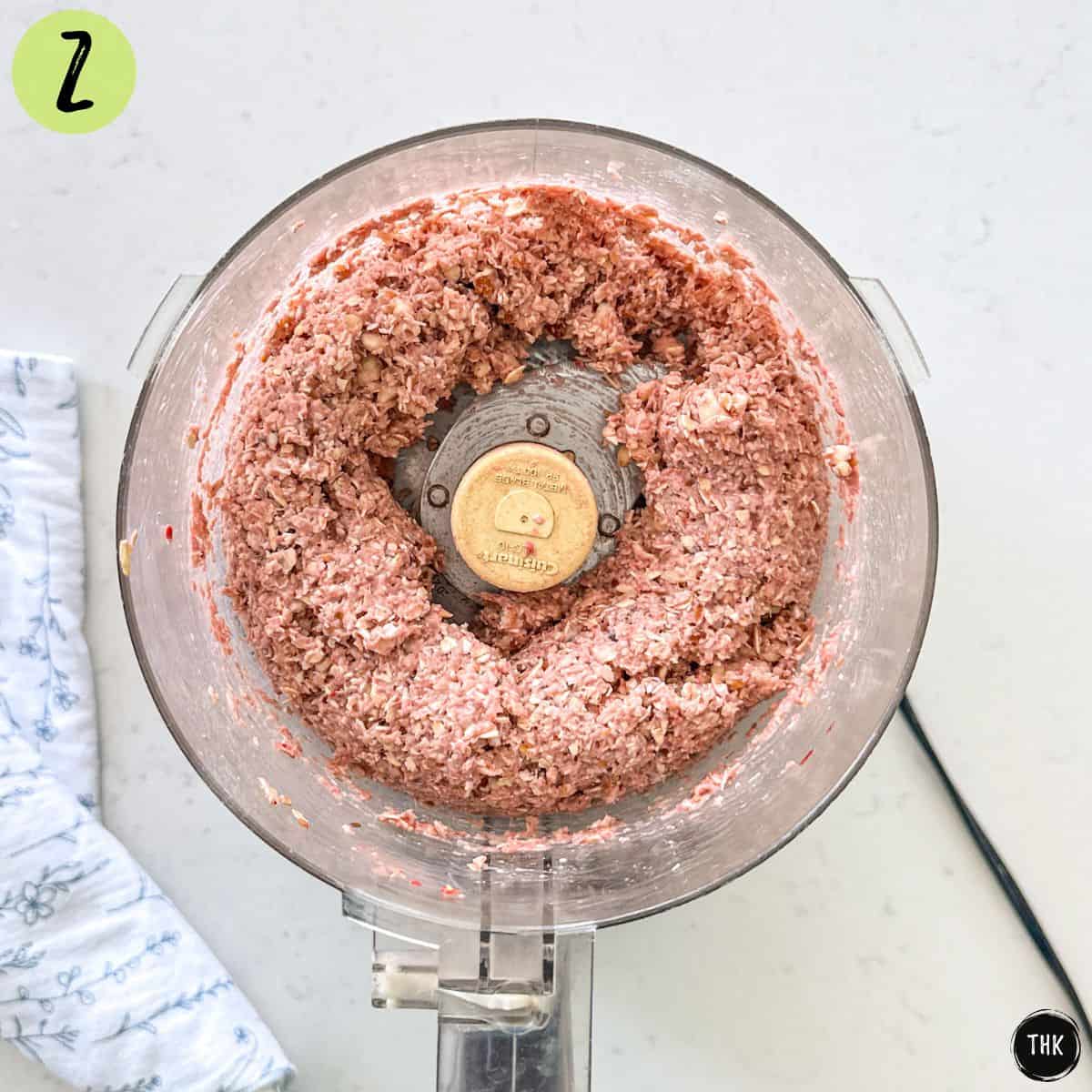 Pink mixture inside food processor bowl.