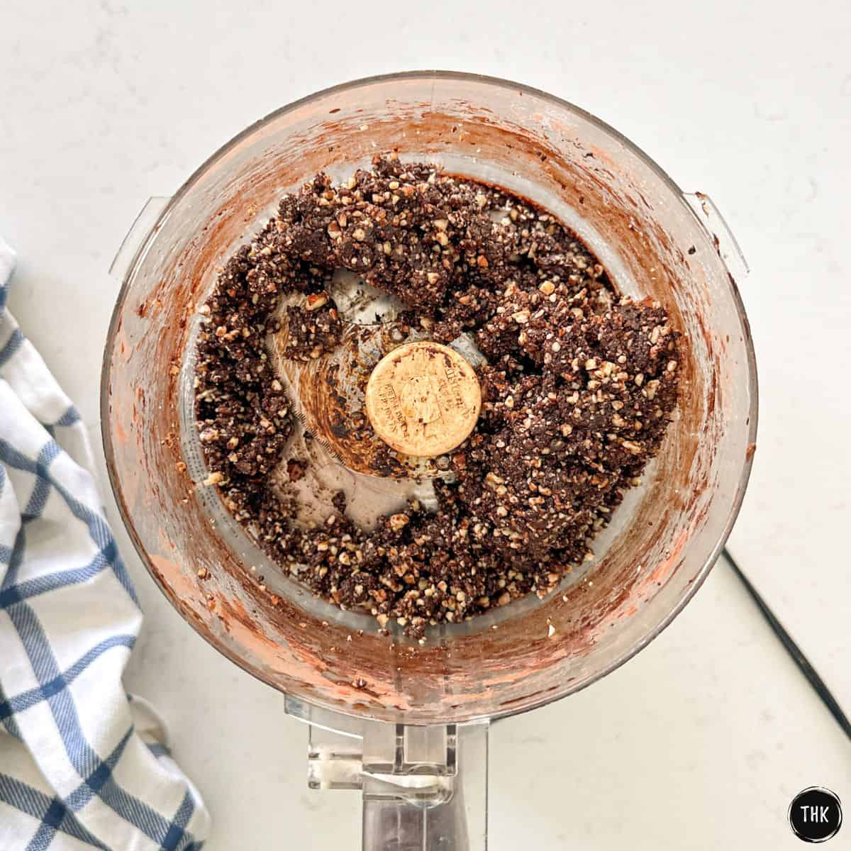 Mocha and date mixture inside food processor bowl.