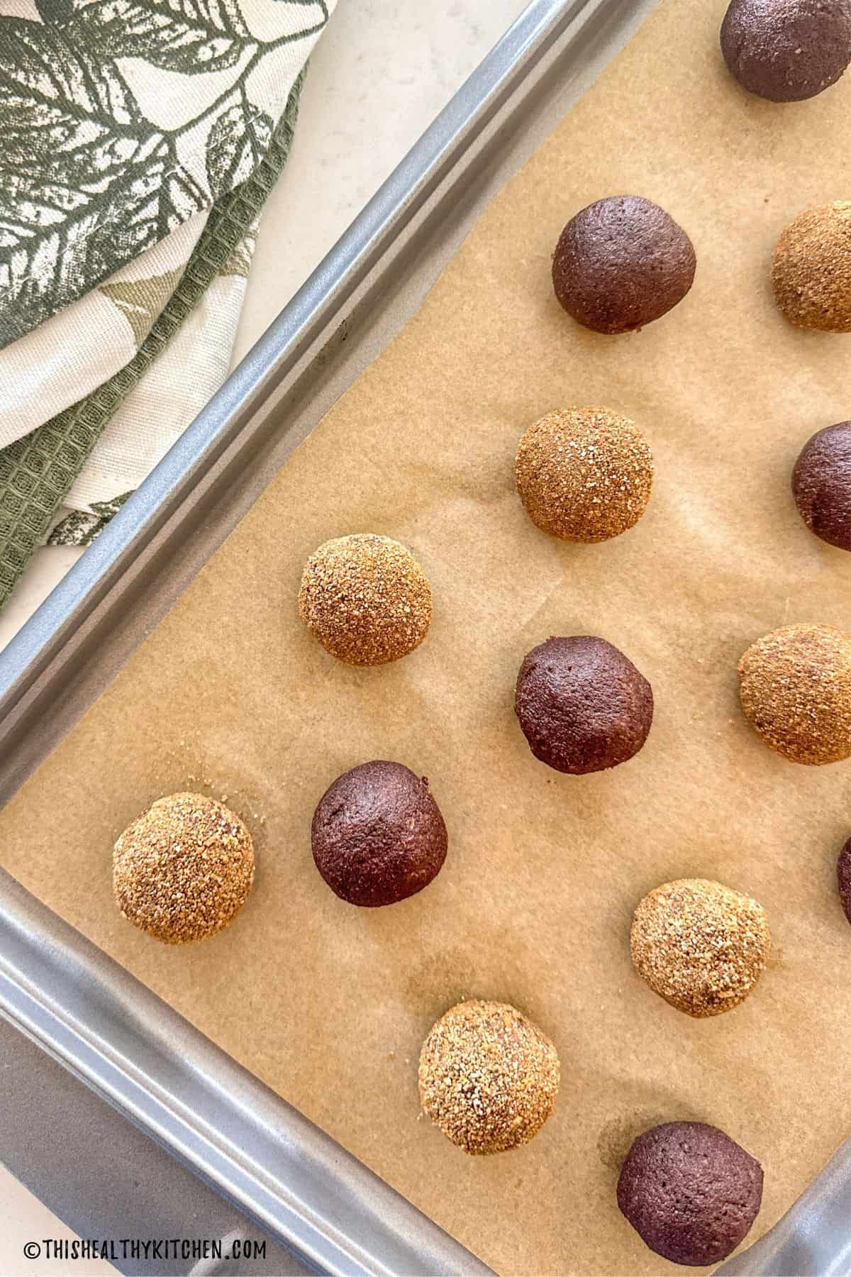Pumpkin protein balls on baking sheet with parchment paper.