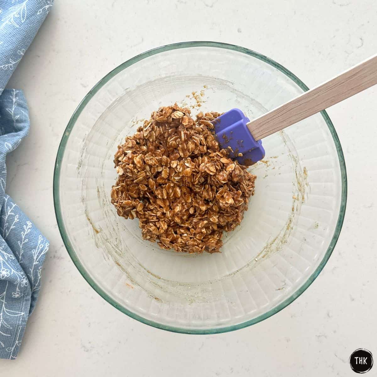 Oatmeal mixture inside large glass mixing bowl.